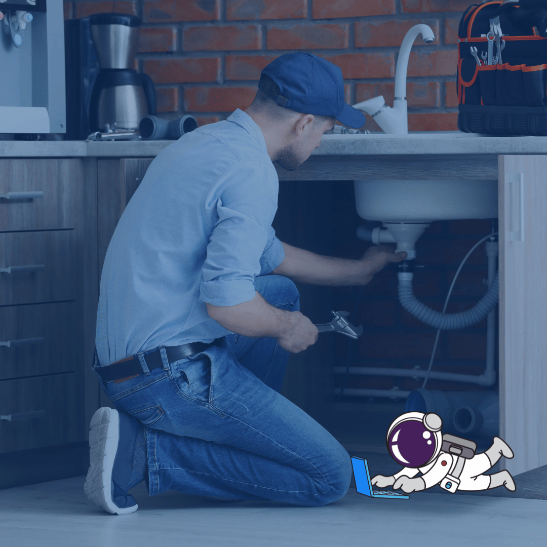 Digital Marketing for Plumbers Main A man repairing a sink in a kitchen.