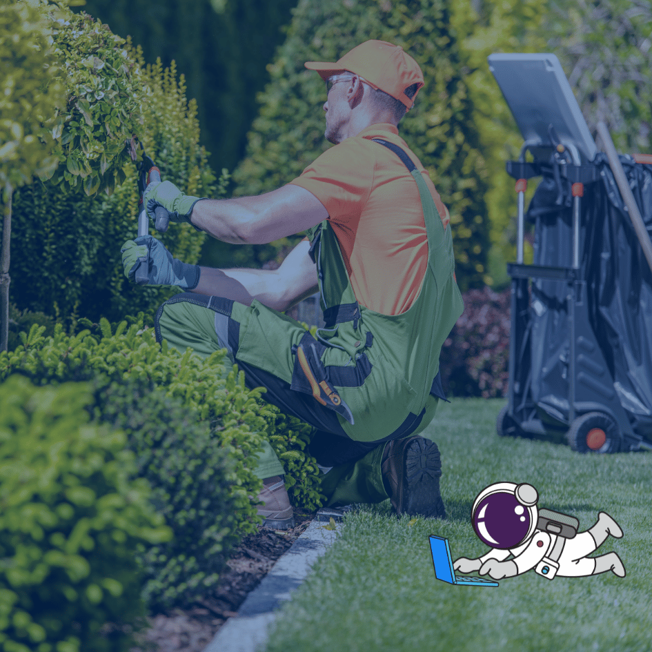 A man in overalls and a backpack trimming a hedge with a tool in hand.